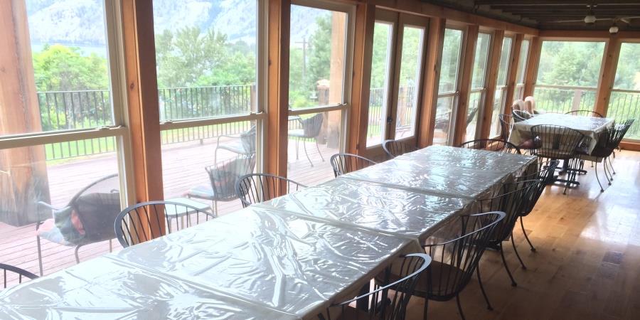 Extensive dining area for large groups on the porch at the Lodge at Palmer Lake